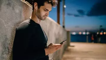 man looking at his mobile device 