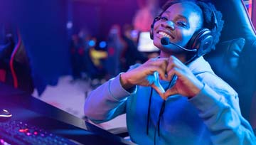 African-American woman gamer giving the heart symbol