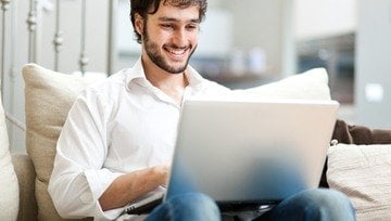 young man playing Vegas casino online games on his laptop