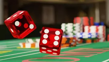 two red dice flying above a gambling table with chips