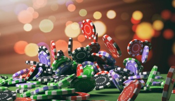 casino chips falling onto a poker table