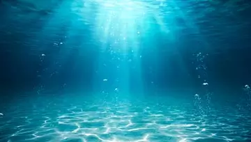 light shining into the sea as seen from under the water