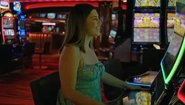 woman playing a slot machine