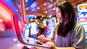 woman playing a slot machine