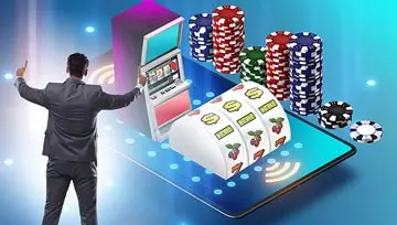 image of a man standing next to a huge mobile phone with a slot machine and casino chips 