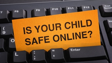 computer keyboard with a sign Is Your Child Safe Online