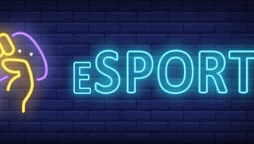 neon writing on a brick background saying eSPORTS with a neon hand holding a gaming console