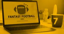 Football, keyboard, paper and pen on table