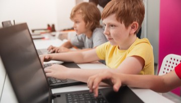 Kids using computers in school