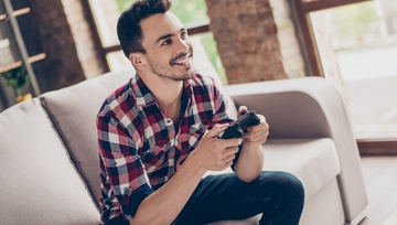 Man enjoying playing video games alone  