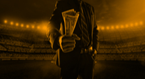 man dressed in suit holding a lot of cash bills on a football field