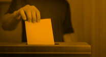 ballot box with man placing his ballot inside