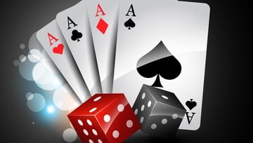 a red and black set of dice and 4 Aces playing cards 