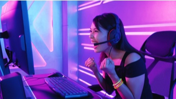 young woman celebrating a win playing on a video game